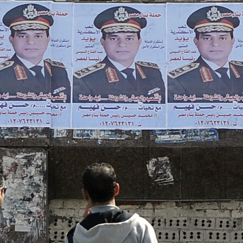 Egyptians look at a row of portraits of Egyptian army chief Abdel Fattah al-Sisi in Alexandria, Egypt (STR/AFP/Getty Images)