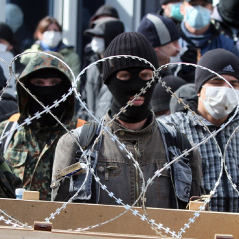 Pro-Russian activists guard a barricade set at the Ukrainian regional Security Service building on the eastern city of Donetsk on April 7, 2014 (Alexander KHUDOTEPLY/AFP/Getty Images)