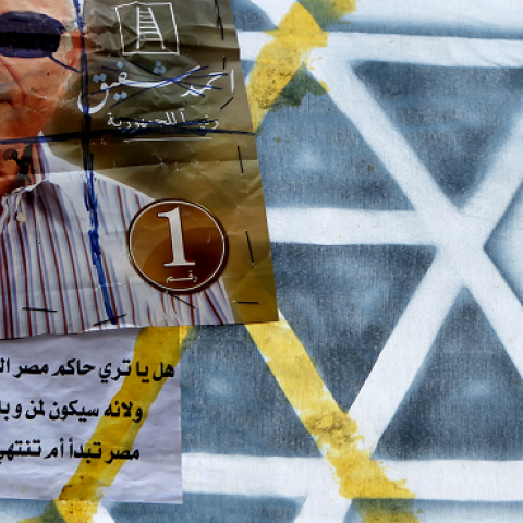 A defaced poster on Israel's Star of David symbol shows Egypt's presidential candidate Ahmed Shafiq looking like late Israeli defense minister Moshe Dayan in Cairo's landmark Tahrir Square on June 23, 2012. (MARWAN NAAMANI/AFP/GettyImages)