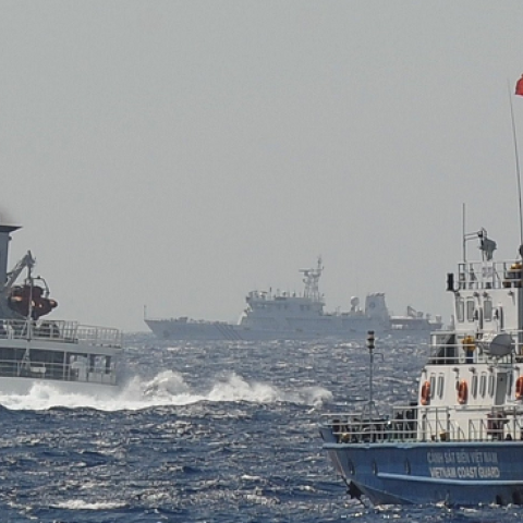 A Chinese coast guard vessel (L) followed by a Vietnamese coast guard ship (R) near the area of China's oil drilling rig in disputed waters in the South China Sea, May 14, 2014. (HOANG DINH NAM/AFP/Getty Images)