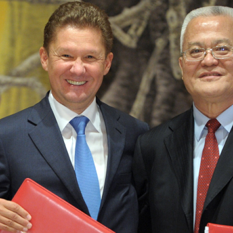 Russia's President Vladimir Putin (L) applauds during an agreement signing ceremony in Shanghai on May 21, 2014, with Gazprom CEO Alexei Miller (C) and Chinese state energy giant CNPC Chairman Zhou Jiping (R). (ALEXEY DRUZHININ/AFP/Getty Images)