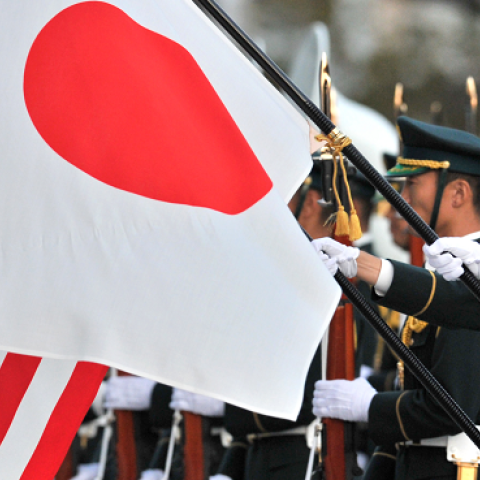 Japanese Ground Self Defense Force honor guards hold national flags for visiting US Army General Martin E. Dempsey at the Defence Ministry in Tokyo on October 28, 2011. (KAZUHIRO NOGI/AFP/Getty Images)