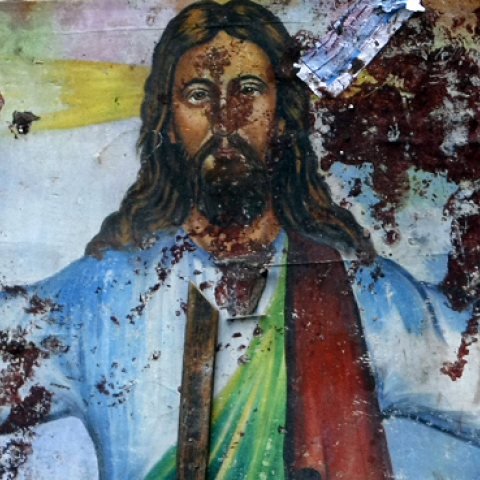 A blood-stained image of Jesus Christ outside the Al-Qiddissine (The Saints) church after an overnight car bomb attack in Alexandria, January 1, 2011. (MOHAMMED ABED/AFP/Getty Images)