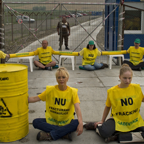Greenpeace activists wave placards saying 'No fracking' and block the entrance of Chevron's shale gas exploring site in Pungesti village on July 7, 2014. (DANIEL MIHAILESCU/AFP/Getty Images)