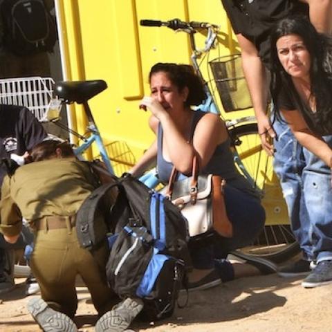 Israeli residents and relatives take cover from a rocket attack from Palestinian militants from the Gaza Strip in Netivot on July 29, 2014. (GIL COHEN MAGEN/AFP/Getty Images)