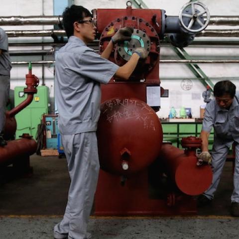 Chinese workers check compressors at Dalian Bingshan Group Co., Ltd. on September 10, 2013 in Dalian of Liaoning Province, China. (Feng Li/Getty Images)