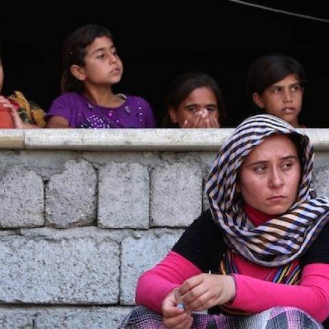 Iraqi Yazidi women who fled the violence in the northern Iraqi town of Sinjar sit in the Kurdish city of Dohuk on August 5, 2014. (SAFIN HAMED/AFP/Getty Images)