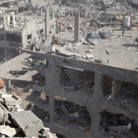 A Palestinian man looks out over destruction in part of Gaza City's al-Tufah neighbourhood as the fragile ceasefire in the Gaza Strip entered a second day on August 6, 2014. (MAHMUD HAMS/AFP/Getty Images)