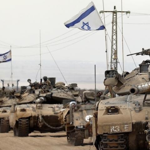 Israeli Merkava tanks drive near the border between Israel and the Gaza Strip on August 5, 2014. (THOMAS COEX/AFP/Getty Images)