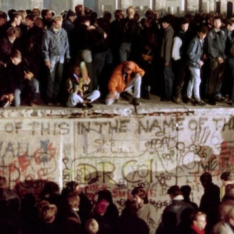 Thousands of young East Berliners crowd atop the Berlin Wall on November 11, 1989. (GERARD MALIE/AFP/Getty Images)