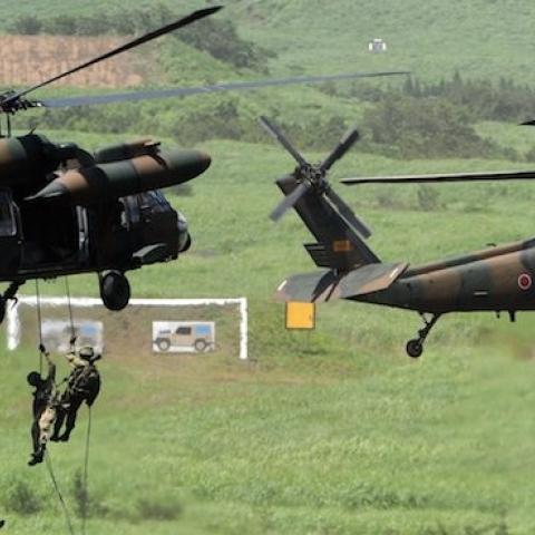 Japanese Ground Self-Defense Forces descend from helicopters at the foot of Mt. Fuji, August 21, 2012. (YOSHIKAZU TSUNO/AFP/GettyImages)