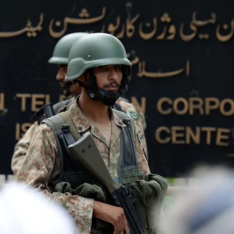 Pakistani soldiers guard the headquarters of state-owned Pakistani Television (PTV) after the building was stormed during anti-government protests in Islamabad on September 1, 2014. (AAMIR QURESHI/AFP/Getty Images)