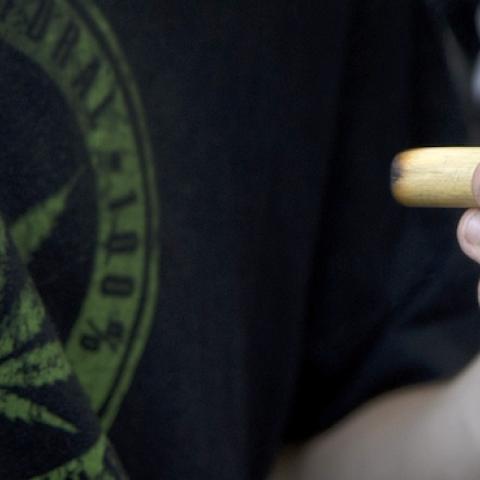 A man smokes a joint during a march for the legalization of marijuana towards the Legislative Palace in Montevideo, on December 10, 2013. (PABLO PORCIUNCULA/AFP/Getty Images)