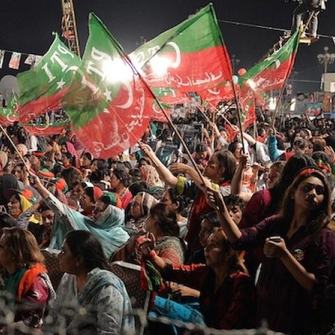 Supporters of Pakistani cricketer-turned politician Imran Khan wave party flags during an anti-government protest in front of the Parliament in Islamabad on September 13, 2014. (AAMIR QURESHI/AFP/Getty Images)
