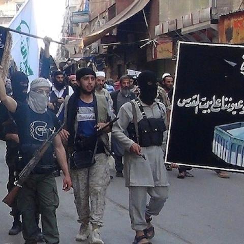 Islamic fighters from the Al-Nusra Front carry a banner of Jerusalem's Dome of the Rock mosque with the Arabic slogan: 'We fight in Syria... and our eyes are on Jerusalem' on July 28, 2014. (RAMI AL-SAYED/AFP/Getty Images)