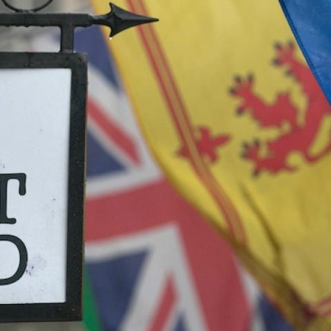 The Saltire flag flies next to the Royal Standard of Scotland and the Union Flag above a gift shop in central Edinburgh on September 19, 2014. (Matt Cardy/Getty Images)
