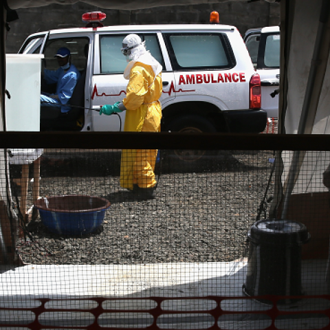 New arrivals suspected of having Ebola await entry as a health worker disinfects an ambulance in a high risk area of the Doctors Without Borders (MSF), treatment center on October 5, 2014 in Paynesville, Liberia. (John Moore/Getty Images)