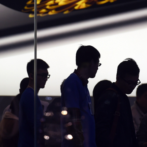 Store attendants help customers at an Apple store selling the iPhone 6 in Beijing on October 23, 2014. (GREG BAKER/AFP/Getty Images)