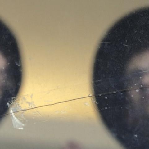 Ultra Orthodox Jews look at bullet holes in the main window of a synagogue in Jerusalem, November 19, 2014. (THOMAS COEX/AFP/Getty Images)