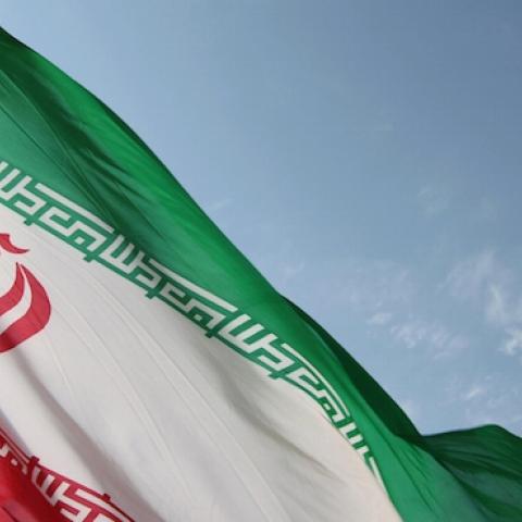 An Iranian flag in the Islamic republic next to a surface-to-surface Qiam-1 (Rising) missile, August 20, 2010. (VAHID REZA ALAEI/AFP/Getty Images)