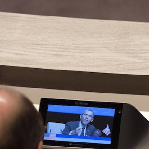 A member of Russia's delegation looks at a monitor showing the speech of US President Barack Obama during the Nuclear Security Summit in The Hague on March 25, 2014. (SAUL LOEB/AFP/Getty Images)