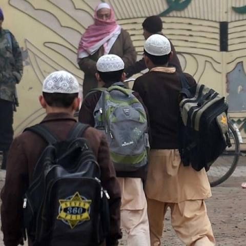 Pakistani children arrive at their school in Peshawar on December 20, 2014, after three days of mourning for the children and staff killed by Taliban militants in an attack on an army-run school. (A Majeed/AFP/Getty Images)