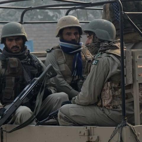 Pakistani soldiers provide security during a mass prayer for the victims of a school massacre, in Peshawar on December 21, 2014. (A Majeed/AFP/Getty Images)