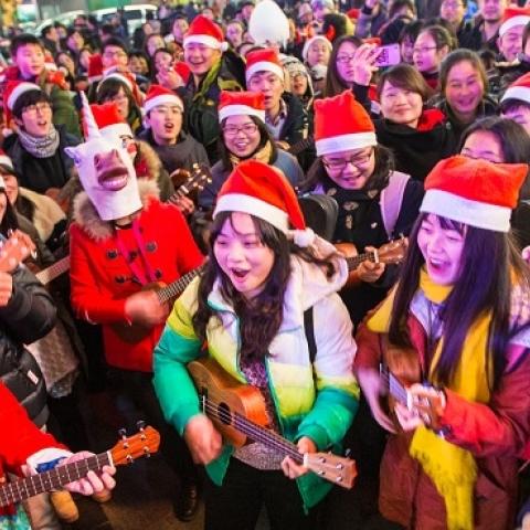 People dressed in Santa Claus costumes attend a celebration for the Christmas Eve at Xinjiekou on December 24, 2013 in Nanjing, China. (ChinaFotoPress/Getty Images)