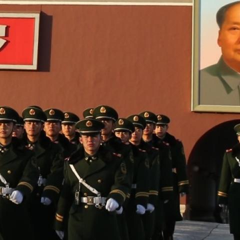 Paramilitary policemen patrol in front of Tiananmen Gate on November 17, 2013 in Beijing, China. (Feng Li/Getty Images)