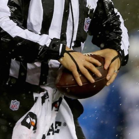 Umpire Carl Paganelli #124 holds a ball on the field after a play during the 2015 AFC Championship Game between the New England Patriots and the Indianapolis Colts at Gillette Stadium on January 18, 2015 in Foxboro, Massachusetts. (Elsa/Getty Images)