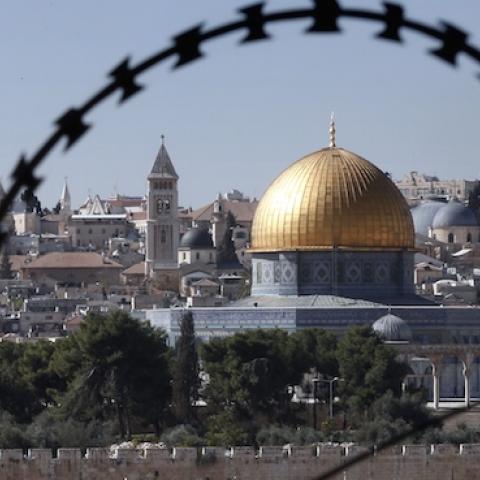 The Jerusalem Old City is seen through barbed wire on November 10, 2014. (THOMAS COEX/AFP/Getty Images)