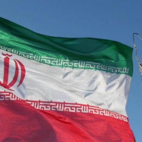 An Iranian flag flutters next to a ground-to-ground Sajil missile before being launched at an undisclosed location in Iran on November 12, 2008. (-/AFP/Getty Images)
