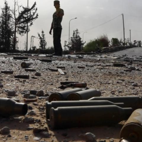 Spent bullet shells litter the ground as a member of the Islamist-linked militia of Misrata walks past following three days of battles in the area of Tripoli's International airport, on August 21, 2014. (MAHMUD TURKIA/AFP/Getty Images)