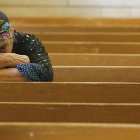 An Iraqi Christian fleeing the violence in the towns of Qaraqush and Bartala prays at the Saint George church on July 1, 2014 in the Kurdish autonomous region's capital Arbil. (KARIM SAHIB/AFP/Getty Images)