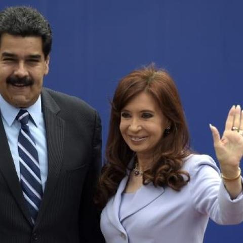 Argentinian President Cristina Kirchner (R) waves next to Venezuelan President Nicolas Maduro during the 47th Mercosur Summit, in Parana, Entre Rios, Argentina on December 17, 2014. (JUAN MABROMATA/AFP/Getty Images)