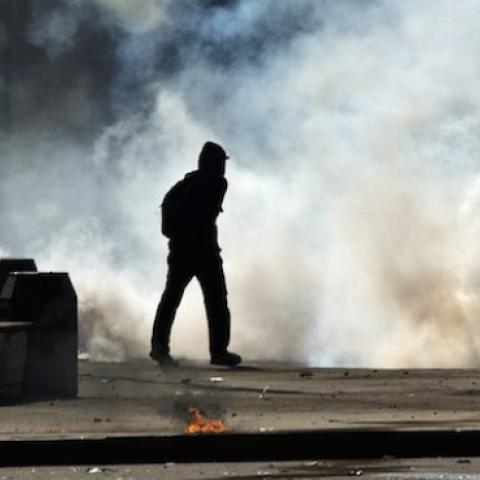 Egyptian students who support the Muslim Brotherhood run from tear gas fired by riot police during clashes following a demonstration outside Cairo University on March 26, 2014. (KHALED DESOUKI/AFP/Getty Images)