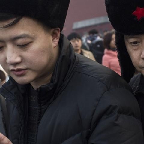 A Chinese man uses his smartphone on November 20, 2014 in Beijing, China. (Kevin Frayer/Getty Images)