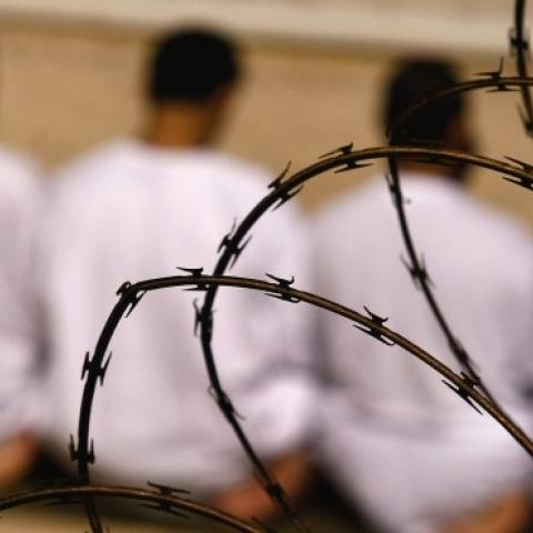 Detainees kneel during early morning Islamic prayer on October 28, 2009 in Guantanamo Bay, Cuba. (John Moore/Getty Images)