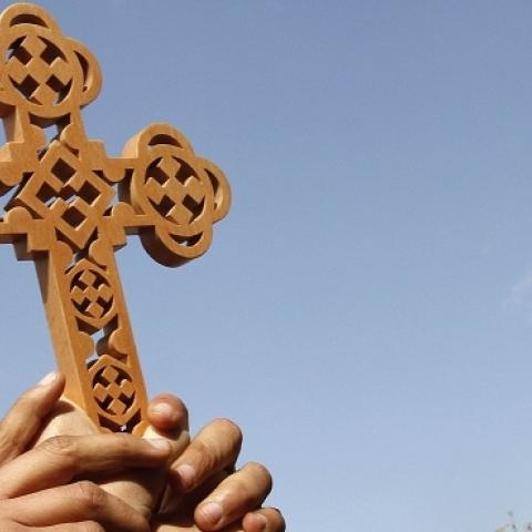 Egyptian Coptic Christians hold a cross high in Cairo's Tahrir square on February 06, 2011. (MOHAMMED ABED/AFP/Getty Images)