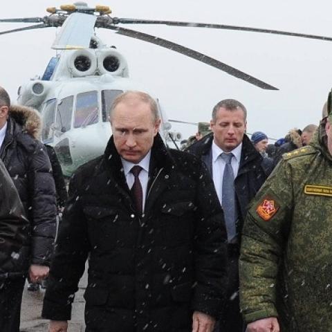 Russia's President Vladimir Putin (front C) and Defence Minister Sergei Shoigu (front L) walk to watch military exercises upon his arrival at the Kirillovsky firing ground in the Leningrad region, on March 3, 2014. (MIKHAIL KLIMENTYEV/AFP/Getty Images)