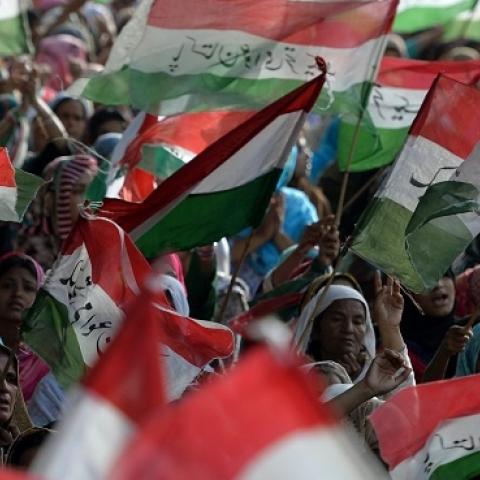 Pakistani supporters wave their party flags during a protest march in Islamabad on August 18, 2014. (AAMIR QURESHI/AFP/Getty Images)