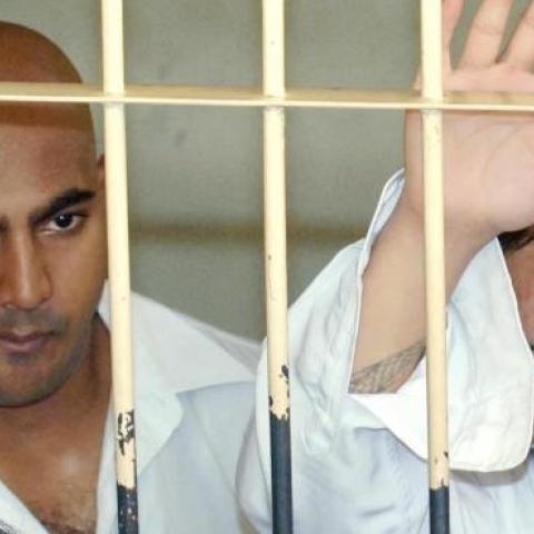 Australians Andrew Chan (R) and Myuran Sukumaran (L) behind the bars of a court cell before their trial in Denpasar, on Bali island, February 14, 2006. (JEWEL SAMAD/AFP/Getty Images)