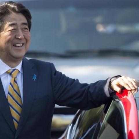 Japanese Prime Minister Shinzo Abe looks on before taking a ride in a Model S P85D with Tesla CEO Elon Musk at Tesla's headquarters in Palo Alto, California on April 30, 2015. (Josh Edelson/AFP/Getty Images)