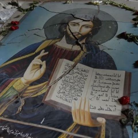 A damaged painting of Jesus Christ on the ground of Syriac Orthodox Um al-Zinar church in Homs, central Syria, May 12, 2014. (JOSEPH EID/AFP/Getty Images)