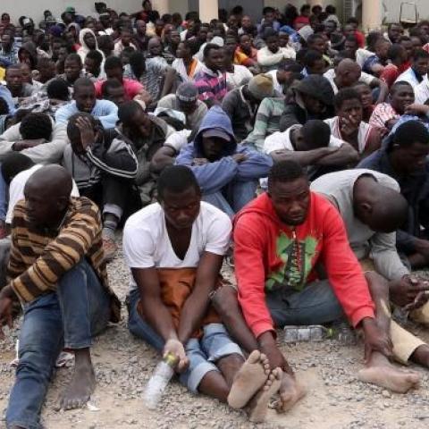 Migrants from sub-Saharan Africa rest inside a detention center in the Libyan capital Tripoli on June 4, 2015. (MAHMUD TURKIA/AFP/Getty Images)