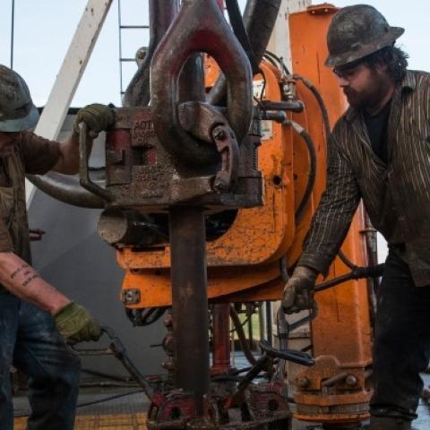 Workers with Raven Drilling line up pipe while drilling for oil in the Bakken shale formation on July 23, 2013 outside Watford City, North Dakota. (Andrew Burton/Getty Images)