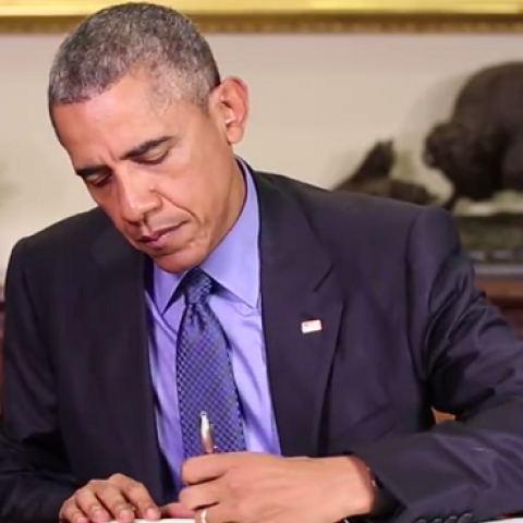 Screenshot of President Obama signing an order commuting the sentences of 46 convicts (Facebook)