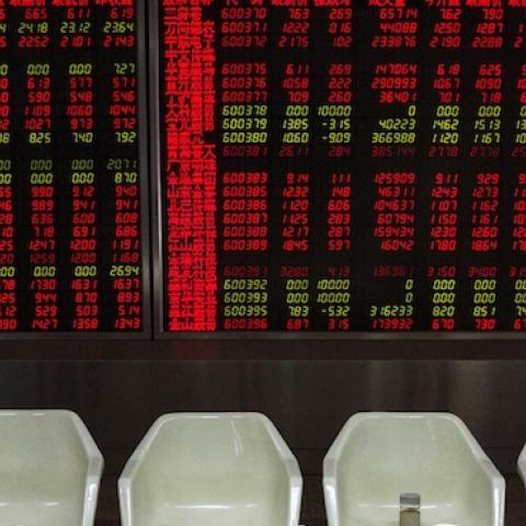 Chinese day traders watch stock tickers at a local brokerage house on August 27, 2015 in Beijing, China. (Kevin Frayer/Getty Images)