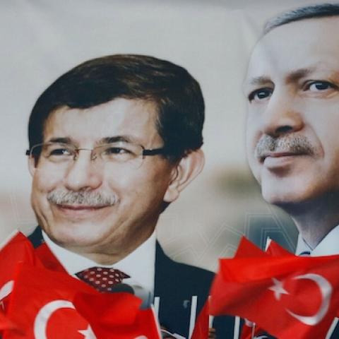 AK Party Supporters in front of the poster of then-Turkish PM Recep Tayyip Erdogan (R) and then-Turkish Foreign Minister Ahmet Davutoglu (L) in Ankara, Turkey on August 27, 2014. (Murat Kaynak/Anadolu Agency/Getty Images)