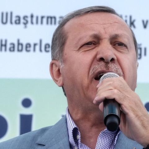 Turkey's President Recep Tayyip Erdogan holds a Koran at the opening ceremony of the Selehaddin Eyyubi airport on May 26, 2015, in eastern city of Hakkari. (STR/AFP/Getty Images)